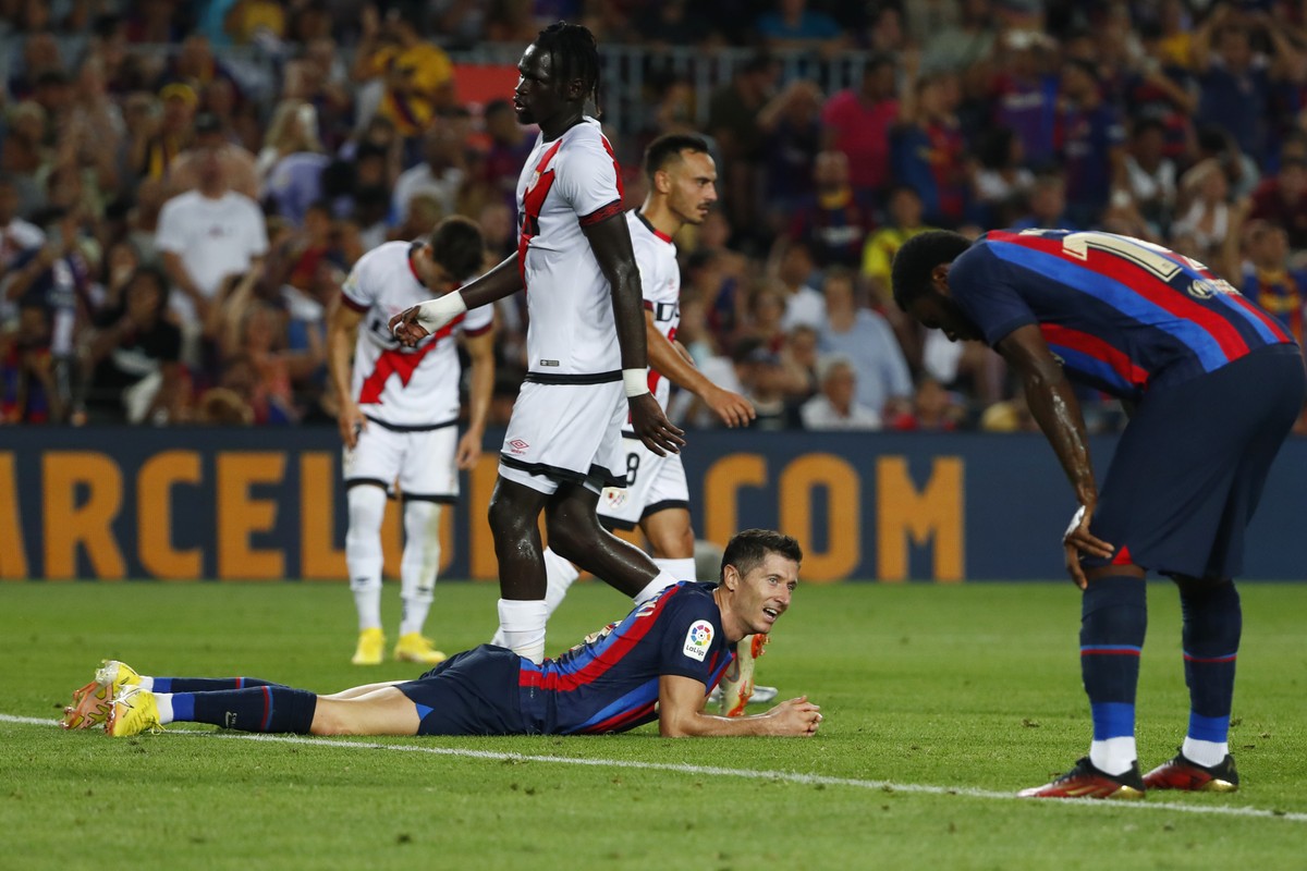 Barcelona's Robert Lewandowski, bottom centre, reacts during a Spanish La Liga soccer match between Barcelona and Rayo Vallecano at the Camp Nou stadium in Barcelona, Spain, Saturday, Aug. 13, 20 ...