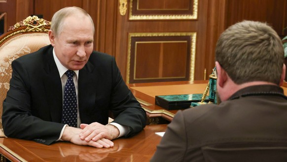 Russian President Vladimir Putin listens to Chechnya&#039;s regional leader Ramzan Kadyrov, back to a camera, during their meeting at the Kremlin in Moscow, Russia, Monday, March 13, 2023. (Mikhail Kl ...