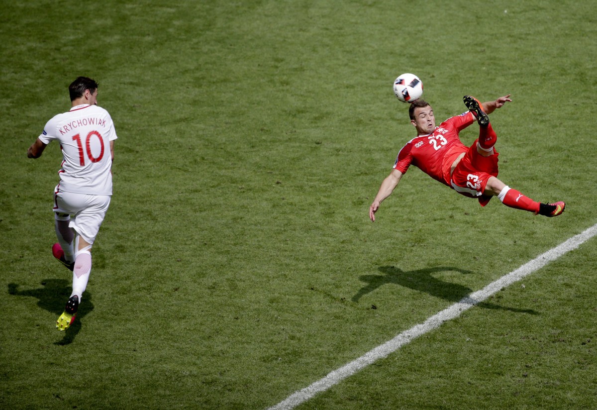 epa05389767 Xherdan Shaqiri of Switzerland scores the 1-1 during the UEFA EURO 2016 round of 16 match between Switzerland and Poland at Stade Geoffroy Guichard in Saint-Etienne, France, 25 June 2016. ...