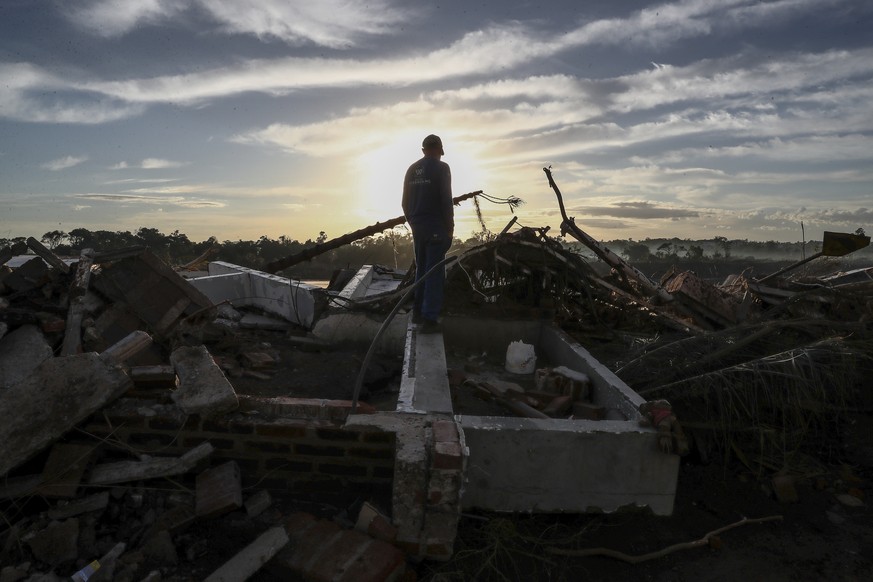 epa11327658 Brazilian Juarez Batista, 62, looks at the place where his house was destroyed by the overflowing of the Taquari river, in Lajeado, Rio Grande do Sul state, Brazil, 08 May 2024. The death  ...