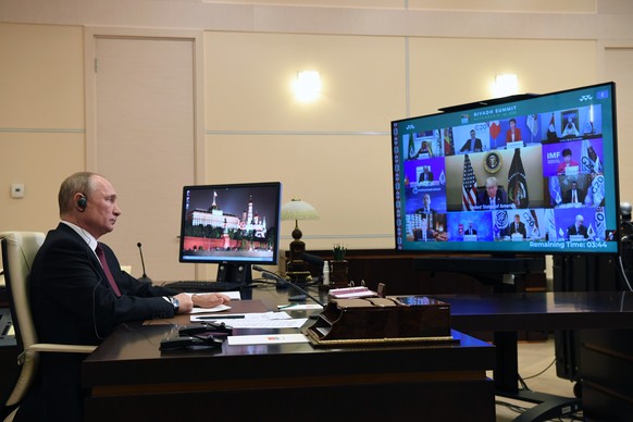 epa08833306 Russian President Vladimir Putin takes part in a virtual G20 Summit 2020 via a videoconference at the Novo-Ogaryovo state residence outside Moscow, Russia, 21 November 2020. The G20 summit ...