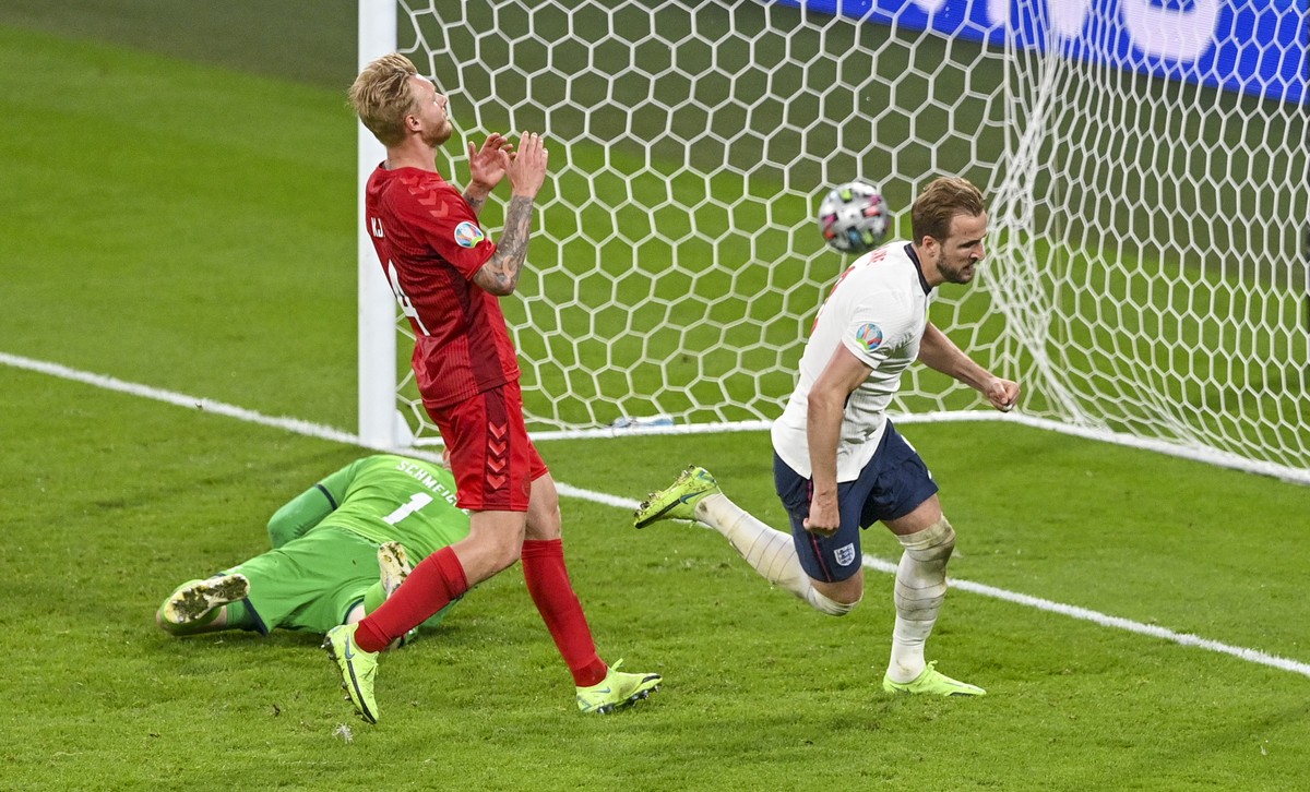 England's Harry Kane, right, reacts after scoring his team's second goal during the Euro 2020 soccer championship semifinal between England and Denmark at Wembley stadium in London, Wednesda ...