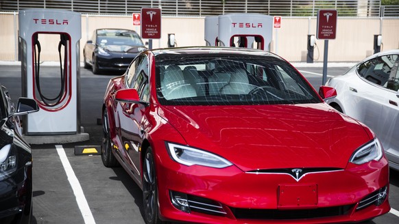 In this Tuesday, July 23, 2019 photo, a Tesla vehicle is parked at a new Tesla Supercharger station next to the LINQ High Roller in Las Vegas. As more electric vehicles hit the streets, more places to ...