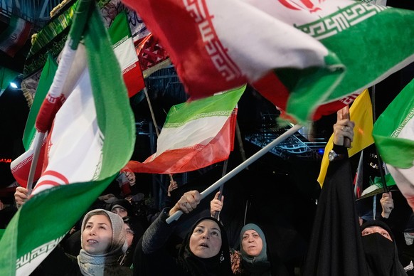 Pro-government demonstrators wave Iranian flags during their gathering at a square in downtown Tehran, Iran, Tuesday, May 19, 2026. (AP Photo/Vahid Salemi)
Iran War