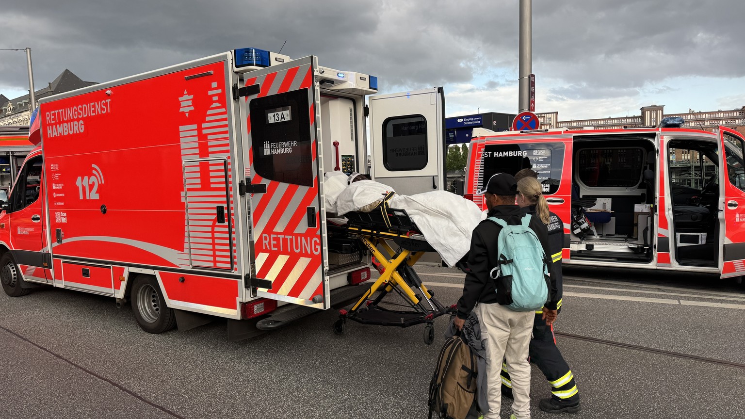 epa12129303 A person is stretchered into an ambulance outside the central station in Hamburg, Germany, 23 May 2025, following a knife attack at the station that left several people wounded, some criti ...