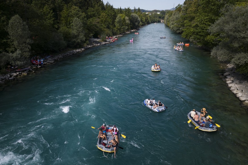 People on inflatable boats sail on the Aare River on the Aare River, at Uttigen, between Thun and Bern, Switzerland, during the sunny and warm weather, Saturday, August 19, 2023. Many parts of Switzer ...