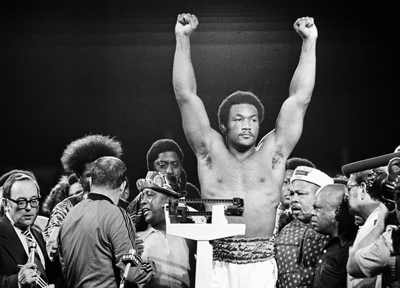 FILE - Heavyweight champion George Foreman responds to cheers of crowd in stadium in Kinshasa, Zaire Saturday night, October 26, 1974 during the weigh in for his title defense against Muhammad Ali. (A ...