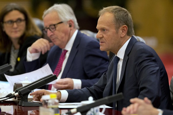 European Council President Donald Tusk, right speaks near European Commission President Jean-Claude Juncker during a meeting with Chinese Premier Li Keqiang, unseen at the Great Hall of the People in  ...