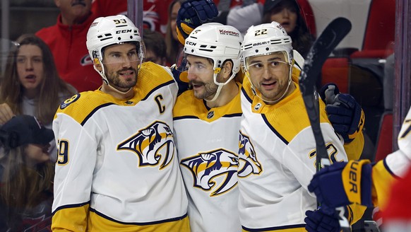Nashville Predators' Filip Forsberg, center, celebrates after his goal with teammates Roman Josi (59) and Nino Niederreiter (22) during the first period of an NHL hockey game against the Carolina ...