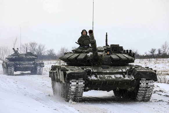 FILE - In this photo provided by the Russian Defense Ministry Press Service on Monday, Feb. 14, 2022, Russian tanks roll on the field during a military drills in Leningrad region, Russia.While the U.S ...
