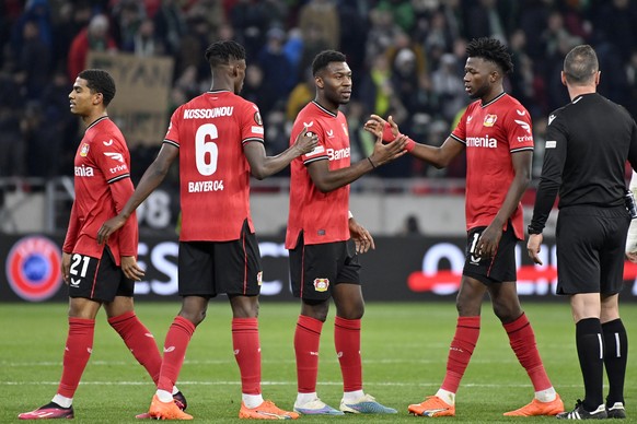 Leverkusen players shake hands at the end of the Europa League round of 16, 2nd leg, soccer match between Ferencvaros and Bayer 04 Leverkusen at the Puskas Arena in Budapest, Thursday, March 16, 2023. ...