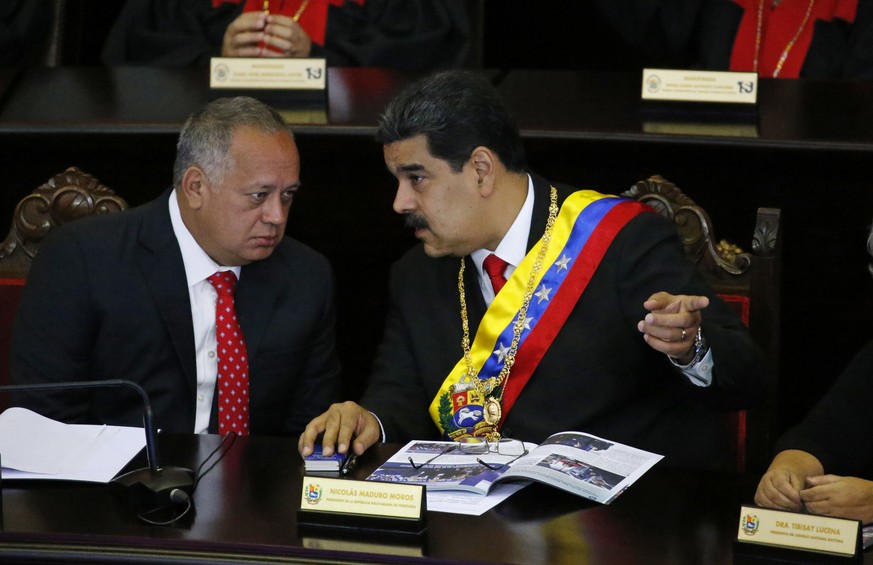 Venezuelan President Nicolas Maduro, right, speaks with Constitutional Assembly President Diosdado Cabello at the Supreme Court during an annual ceremony that marks the start of the judicial year in C ...