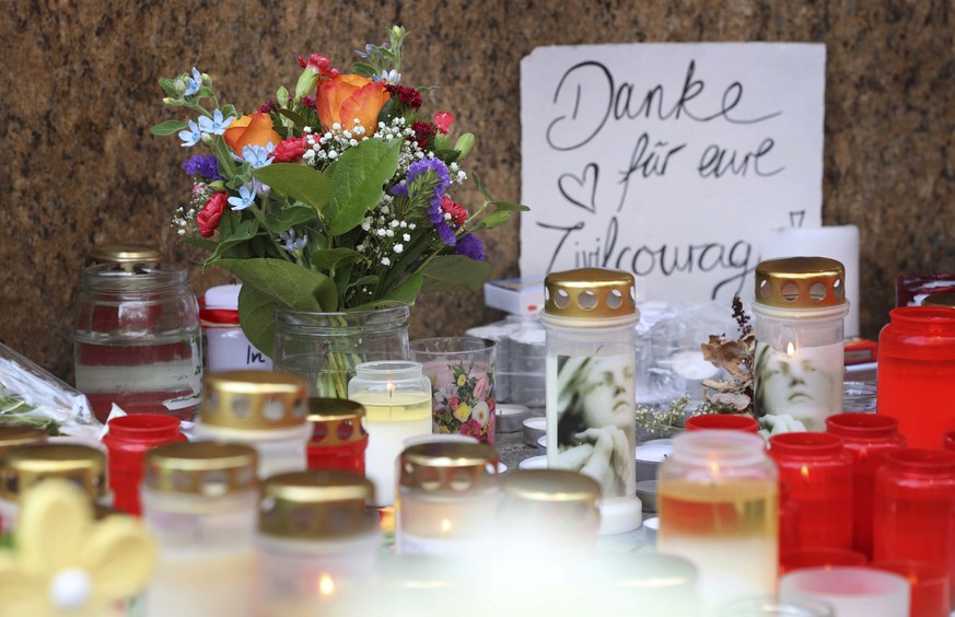 &quot;Thank you for your civil courage&quot; can be read on a sign in front of a closed and cordoned off department store in the city centre of Wuerzburg, Germany, Saturday, June 26, 2021. Authorities ...