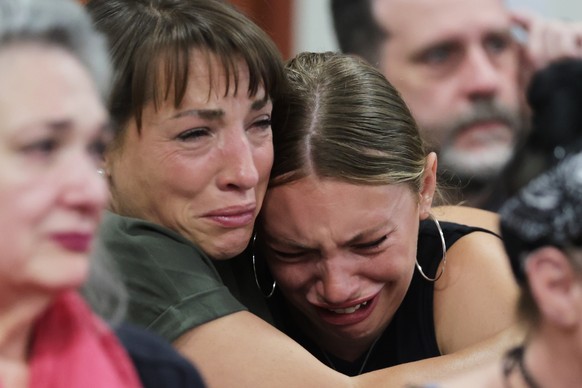 epaselect epa12257051 Dylan Mortensen (R) gets a hug after speaking during the sentencing hearing of Bryan Kohberger at the Ada County Courthouse, in Boise, Idaho, USA, 23 July 2025. Kohberger was sen ...