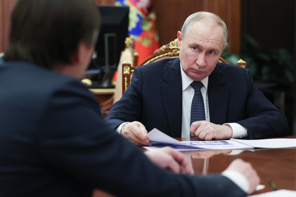 Russian President Vladimir Putin, right, listens to Russian Minister of Education Sergei Kravtsov during their meeting at the Kremlin in Moscow, Wednesday, March 11, 2026. (Gavriil Grigorov, Sputnik,  ...