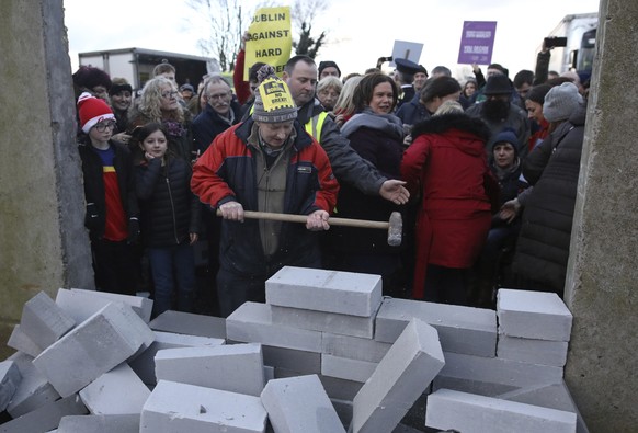 A demonstrator knocks down a &#039;mock&#039; wall on the Northern Ireland/Republic of Ireland border, near Newry in Northern Ireland, Saturday, Jan. 26, 2019. Protesters angered at the prospect of a  ...