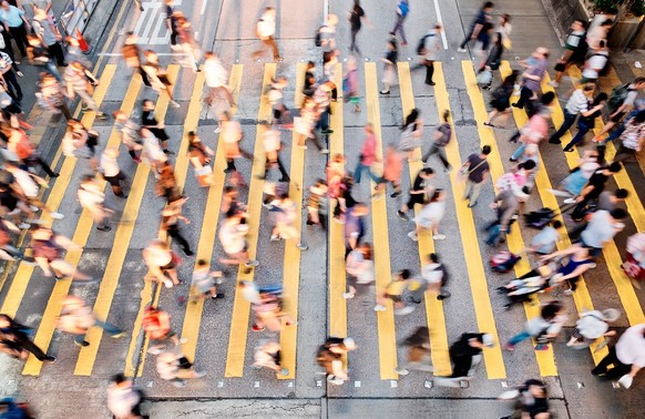 Hectic pedestrian crossing during rush hour.