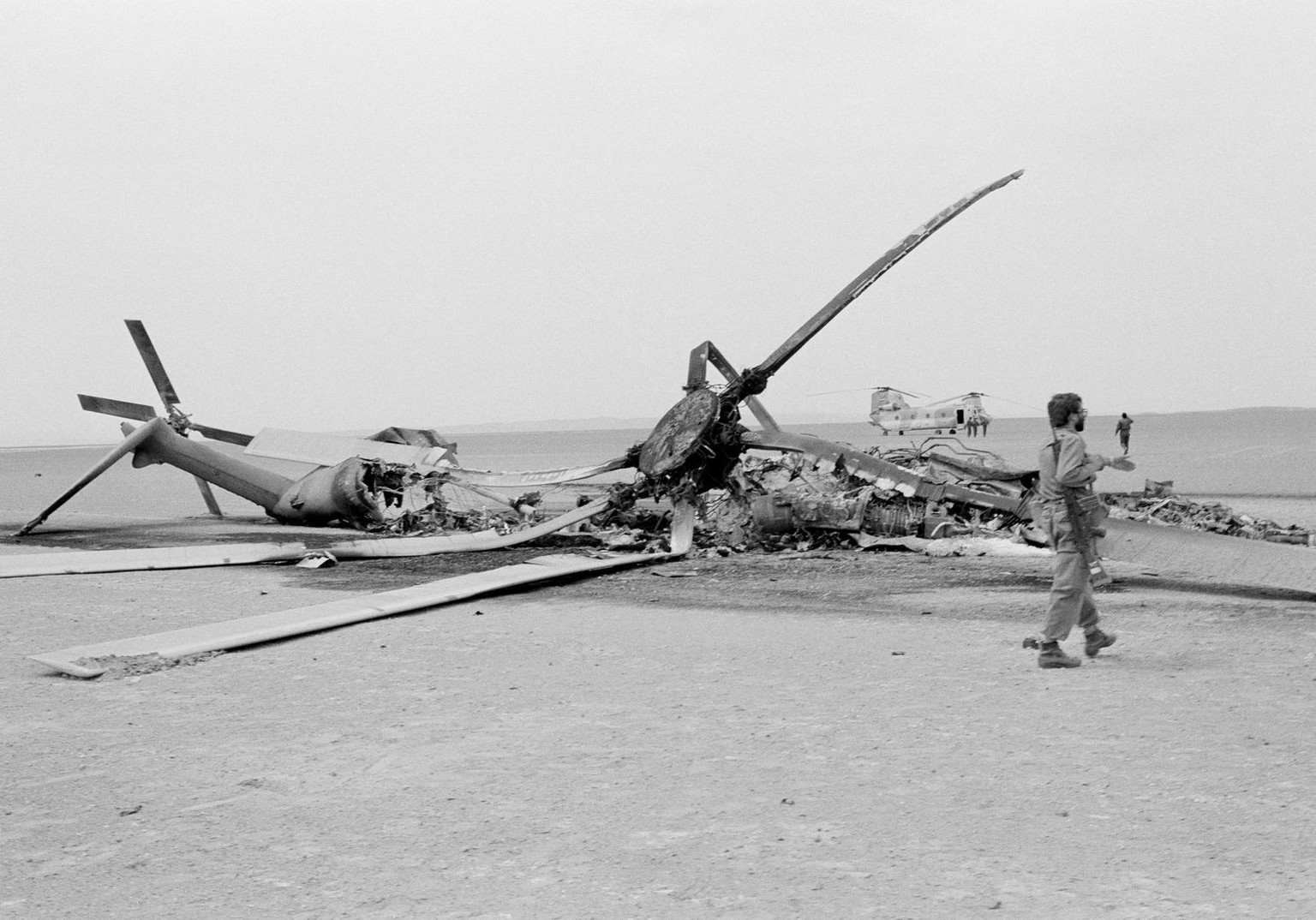 A charred RH53 helicopter forms a grim reminder as it lies on the desert sands of eastern Iran, April 28, 1980. It is one of five helicopters and a C-130 transport, abandoned by a U.S. force that brok ...