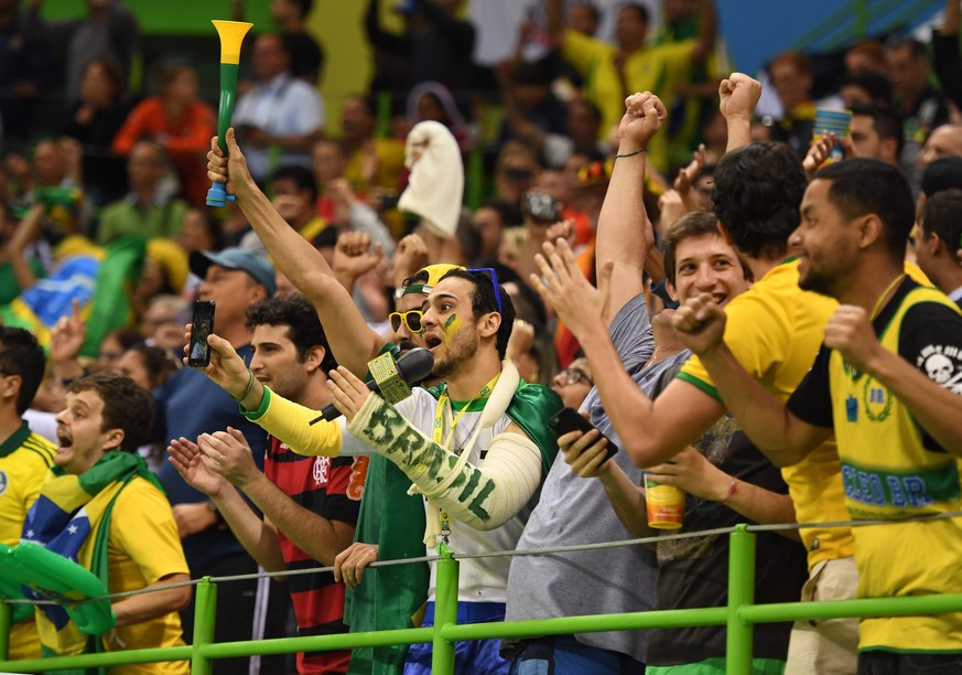 epa05475326 Supporters of Brazil celebrate after the men&#039;s preliminary round match between Brazil and Germany for the Rio 2016 Olympic Games handball tournament at the Future Arena in the Olympic ...