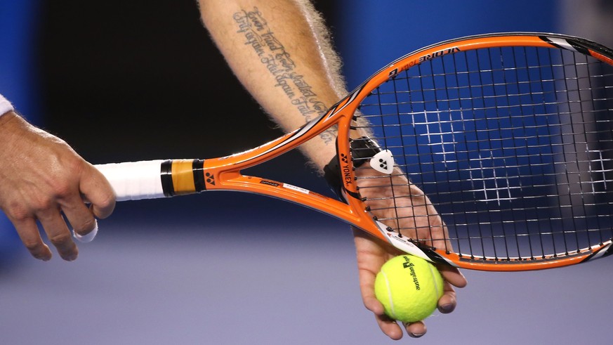 MELBOURNE, AUSTRALIA - JANUARY 30: Detail of the tattoo on the arm of Stanislas Wawrinka of Switzerland in his semifinal match against Novak Djokovic of Serbia during day 12 of the 2015 Australian Ope ...