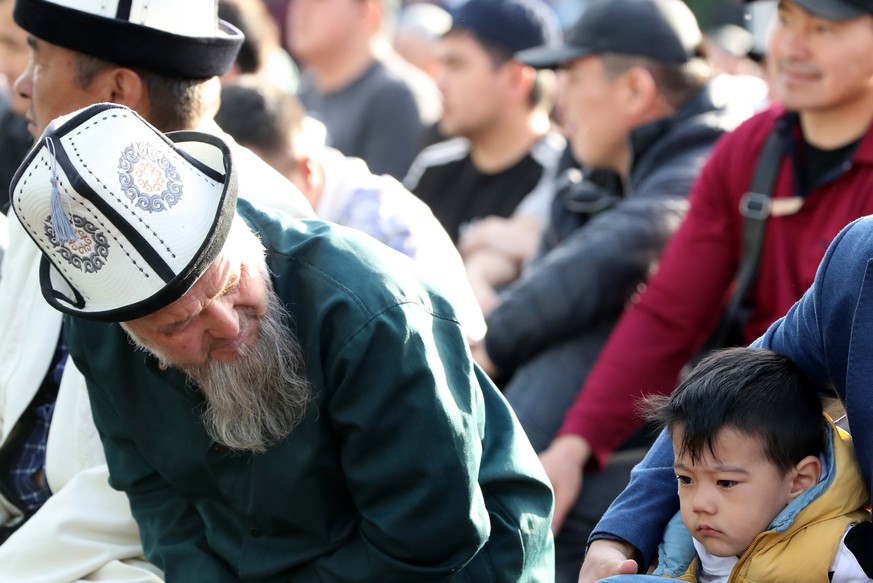 epa09922006 A Kyrgyz Muslim man looks at a boy as they offer Eid al-Fitr prayers in Bishkek, Kyrgyzstan, 02 May 2022. Muslims around the world celebrate Eid al-Fitr, the three days festival marking th ...