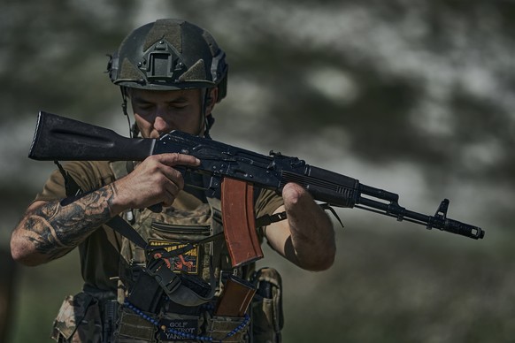 A Ukrainian soldier, code name Ara, who lost his hand a year ago in a battle with the Russian troops close to Bakhmut, holds his machine gun at the front line near Bakhmut, Donetsk region, Ukraine, Tu ...