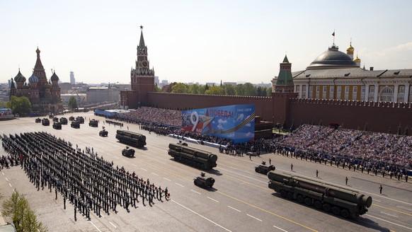FILE - Russian military vehicles roll down Red Square Red Square during a rehearsal for the Victory Day military parade in Moscow, Russia, on May 7, 2019. Some in the West think Russian President Vlad ...