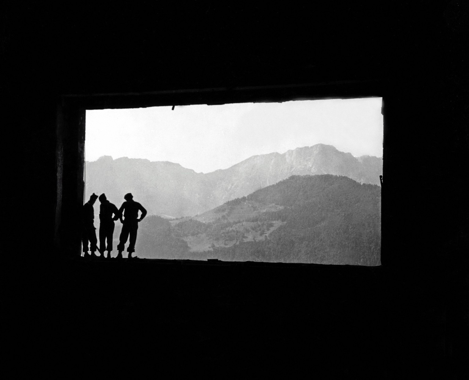 GIs in silhouette can be seen standing in the ruins of Hitler&#039;s mountain retreat, the Berghof, Obersalzberg, Germany, World War II, June 1945. (Photo by Tony Vaccaro/Getty Images)