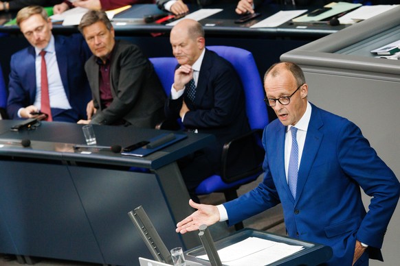 epa11662252 Chairman of the Christian Democratic Union (CDU) party and faction Friedrich Merz (R) speaks in front of German Chancellor Olaf Scholz (3-L), German Minister for Economy and Climate Robert ...