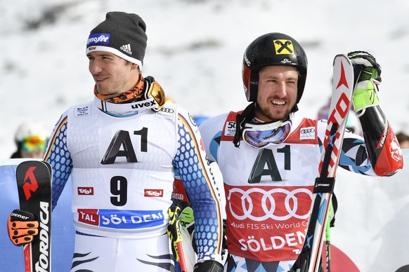 Third placed Felix Neureuther of Germany, left, and second placed Marcel Hirscher of Austria, are pictured the men&#039;s Giant Slalom race of the FIS Alpine Ski World Cup season on the Rettenbach gla ...