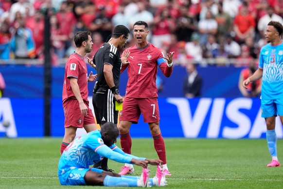 Portugal's Cristiano Ronaldo argues with Referee Abdulrahman Al-Jassim, of Qatar, after he showed a yellow card to Bernardo Silva, left, during the World Cup Group K soccer match between Portugal ...