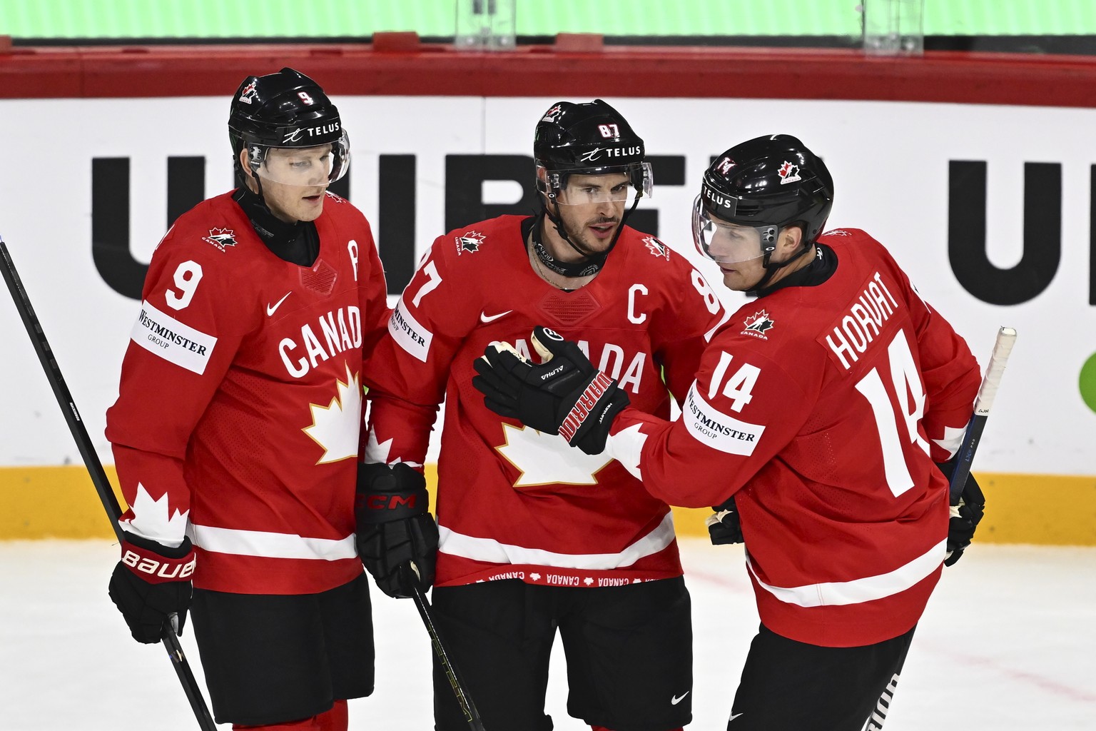 Canada&#039;s Sidney Crosby, center, celebrates after scoring with teammates Nate MacKinnon, left, and Bo Horvat during the IIHF Ice Hockey World Championship group A match between Canada and France a ...