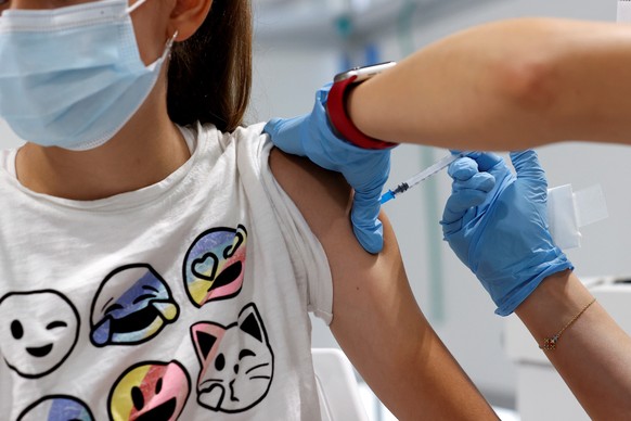 epa09409455 A teenager receives a dose of a vaccine against COVID-19 at a hospital in Madrid, Spain, 11 August 2021. Madrid begins to vaccinate children over 12 years old, a measure that is already st ...