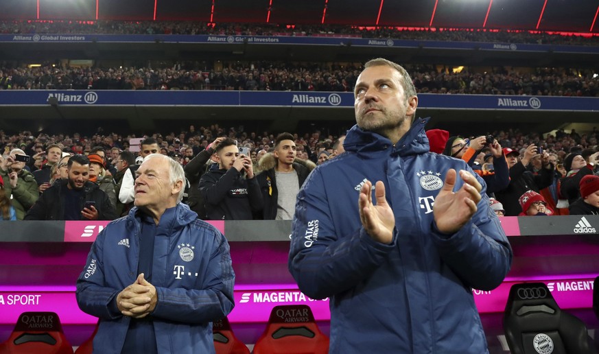 Bayern&#039;s interim coach Hansi Flick, right, applauds before the German Bundesliga soccer match between FC Bayern Munich and Borussia Dortmund, in Munich, Germany, Saturday, Nov. 9, 2019. (AP Photo ...