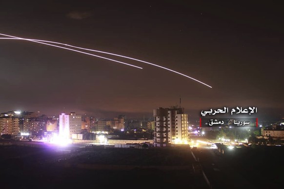 This photo provided early Thursday, May 10, 2018, by the government-controlled Syrian Central Military Media, shows missiles rise into the sky as Israeli missiles hit air defense position and other mi ...