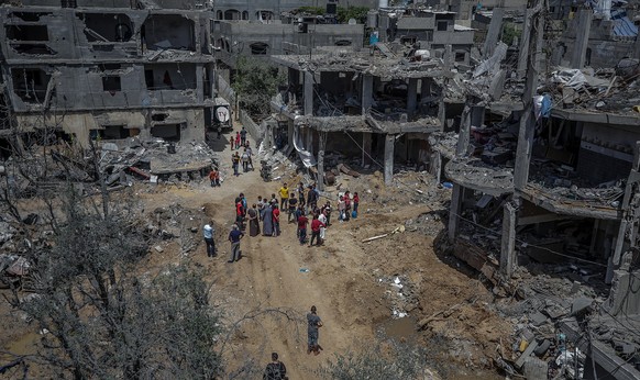 epa09219033 Palestinians inspect the rubble of their destroyed houses after a ceasefire between Israel and Gaza fighters, in Beit Hanun, northern Gaza Strip, 21 May 2021. After 11 days of fighting a c ...