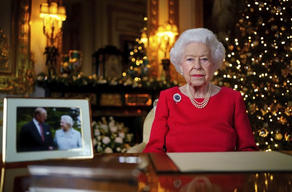 In this undated photo issued on Thursday Dec. 23, 2021, Britain&#039;s Queen Elizabeth II records her annual Christmas broadcast in Windsor Castle, Windsor, England. The photograph at left shows the q ...