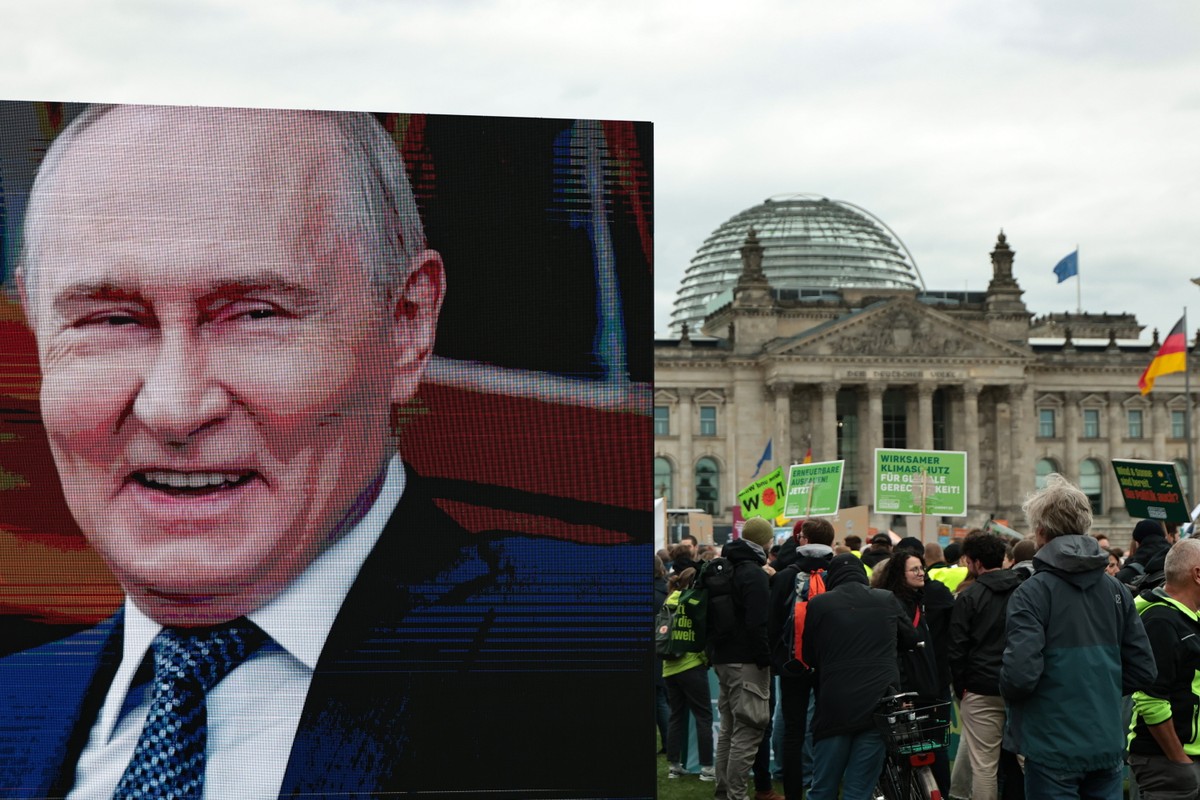 epaselect epa13291859 The image of Russian President Vladimir Putin is on display during a protest titled 'Renewable Energy: Expand, Don't Hold Back! in front of the German Bundestag parliam ...
