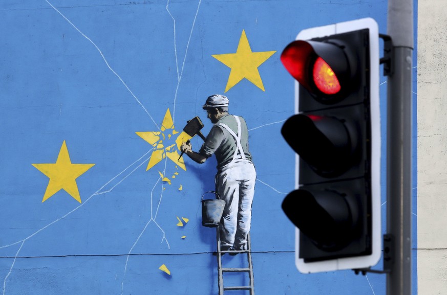 A view of the Banksy Brexit mural of a man chipping away at the EU flag in Dover, England, Tuesday, Dec. 11, 2018. Top European Union officials on Tuesday ruled out any renegotiation of the divorce ag ...