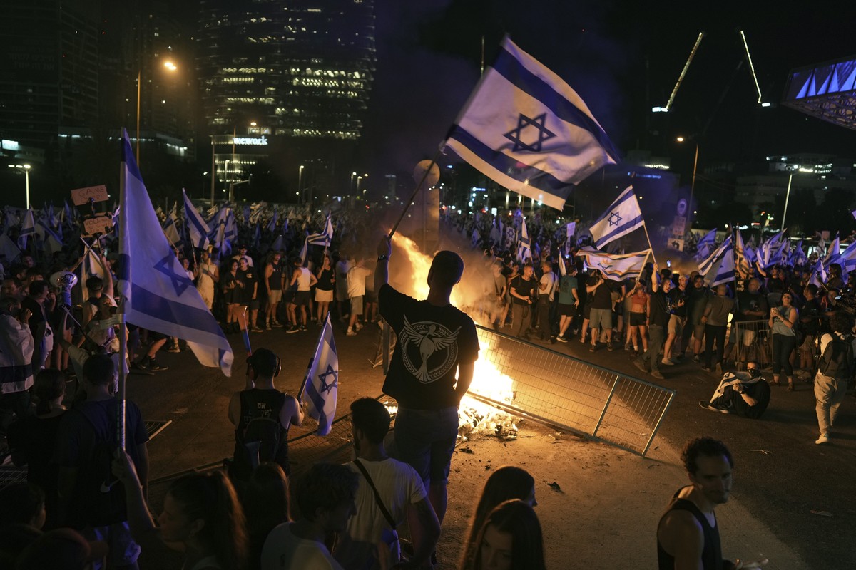 Demonstrators protest against plans by Prime Minister Benjamin Netanyahu's government to overhaul the judicial system, in Tel Aviv, Monday, July 24, 2023. Israeli lawmakers on Monday approved a k ...