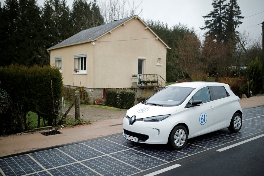 An automobile drives on a solar panel road during its inauguration in Tourouvre, Normandy, northwestern France, December 22, 2016. REUTERS/Benoit Tessier