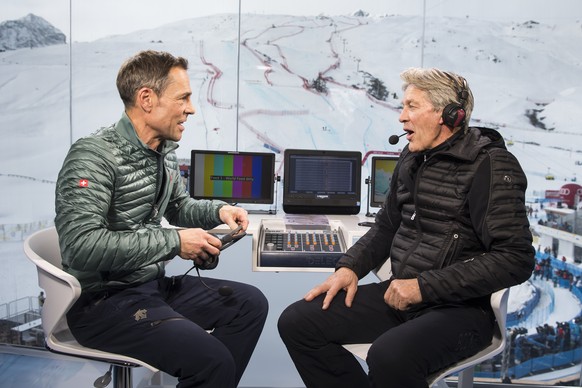 Matthias Hueppi, left, and Bernhard Russi, right, commentators of the Swiss TV, SRF, react in the studio during the 2017 FIS Alpine Skiing World Championships in St. Moritz, Switzerland, Tuesday, Febr ...