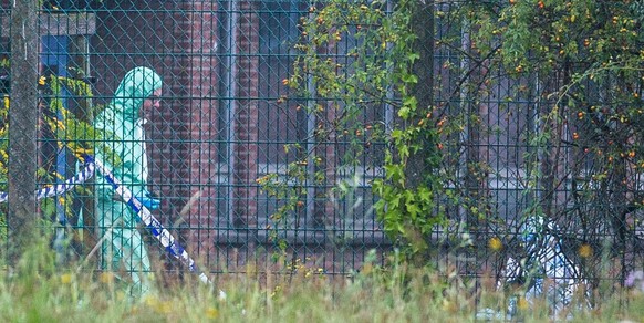 epa05513760 A member of the investigation team at the Brussels Criminology Institute building after a car containing a bomb rammed through three fences, leading to an explosion and a large fire, at th ...