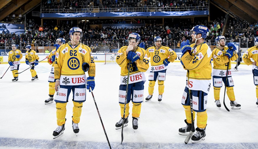 Davos&#039; Felicien Du Bois, Davos&#039; Yannick Frehner and Davos&#039; Enzo Corvi after losing the game between TPS Turku and HC Davos, at the 93th Spengler Cup ice hockey tournament in Davos, Swit ...