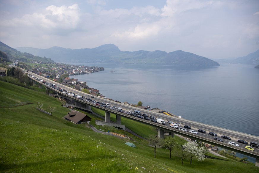 epa09891431 Cars and coaches heading south stand still in a traffic jam on the highway A2 between Amsteg and Beckenried on Good Friday, Switzerland, 15 April 2022. The traffic jam reached a maximum le ...