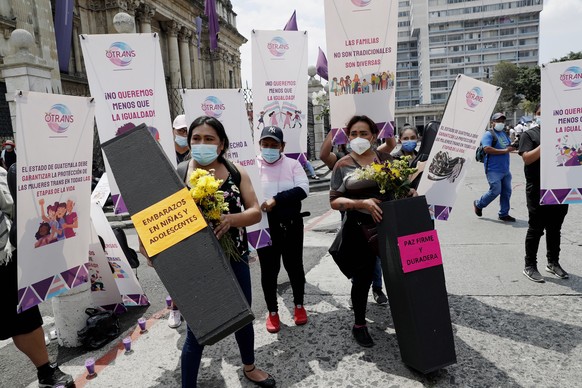 epa09813469 Social organizations protest with coffins during a message from the president of Guatemala, Alejandro Giammattai, for the declaration as the Ibero-American Pro-Life capital, in Guatemala C ...