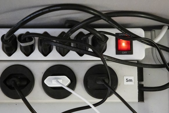 Stromstecker stecken in einer Stromleiste unter einem Buerotisch im Medienzentrum des Bundeshauses, am Mittwoch, 24. August 2022 in Bern. (KEYSTONE/Peter Klaunzer)