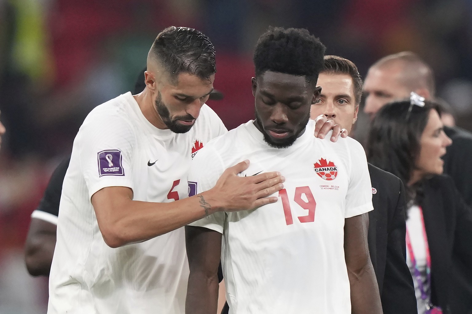 Canada defender Steven Vitoria (5) consoles forward Alphonso Davies (19) after their loss to Belgium in a World Cup group F soccer match between Belgium and Canada at the Ahmad Bin Ali Stadium in Al R ...