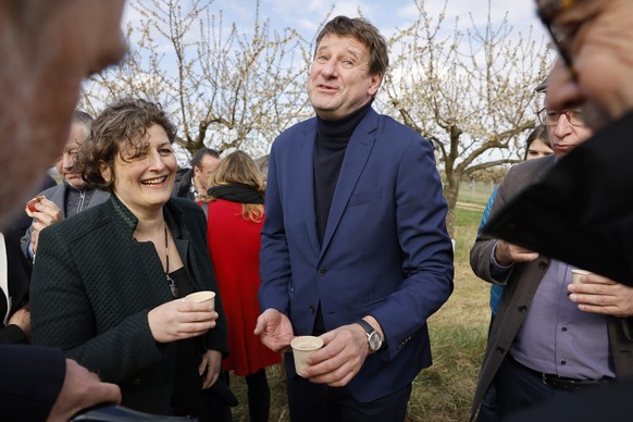 French green party presidential candidate, Yannick Jadot, jokes with Strasbourg mayor Jeanne Barseghian, as he meets Evelyne Hermann, a farmer victim of frost after plunging April temperatures around  ...