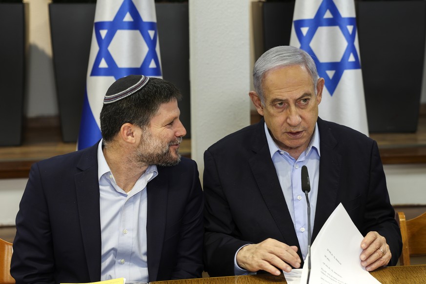 epa11062076 Israeli Prime Minister Benjamin Netanyahu (R) speaks with Minister of Finance Bezalel Smotrich during the weekly cabinet meeting at the Defence Ministry in Tel Aviv, Israel, 07 January 202 ...
